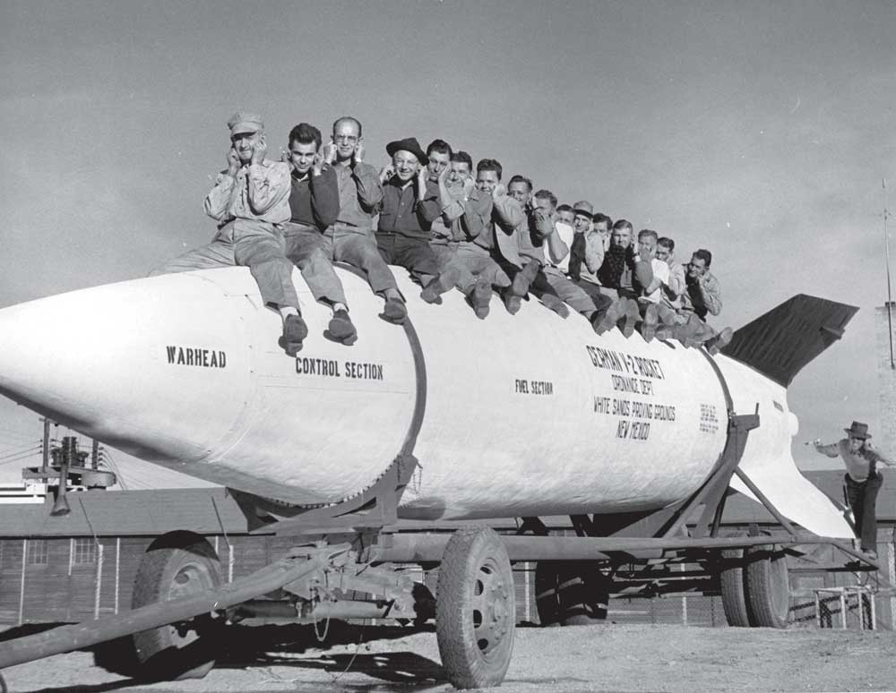 GE employees: General Electric employees posing on a V-2 rocket at White Sands Proving Ground (now White Sands Missile Range) in New Mexico. (Courtesy of White Sands Missile Range)